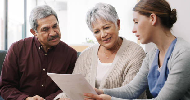 Shot of a senior couple having a consultation with a doctor at home